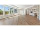 Spacious living room featuring large windows, hardwood floors, and easy access to the kitchen at 5245 Maggie Mae Ln, Cumming, GA 30028