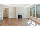 Inviting living room with a stone fireplace, hardwood floors, and bright natural lighting at 5245 Maggie Mae Ln, Cumming, GA 30028