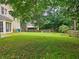 Spacious backyard with a large grassy area and mature trees at 4503 Balmoral Nw Rd, Kennesaw, GA 30144