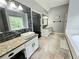 Double vanity bathroom with granite countertop and large soaking tub at 4503 Balmoral Nw Rd, Kennesaw, GA 30144