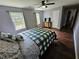 Bright bedroom with a green and white comforter, hardwood floors and large windows at 4503 Balmoral Nw Rd, Kennesaw, GA 30144