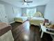 Well-lit bedroom with two twin beds, hardwood floors, and ample natural light at 4503 Balmoral Nw Rd, Kennesaw, GA 30144