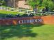 Brick clubhouse entrance with landscaping and a white sign at 4503 Balmoral Nw Rd, Kennesaw, GA 30144