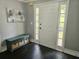 Bright entryway with dark hardwood floors, a bench, and a large front door at 4503 Balmoral Nw Rd, Kennesaw, GA 30144