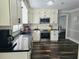 Spacious kitchen with white cabinets and black countertops at 4503 Balmoral Nw Rd, Kennesaw, GA 30144