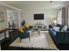 Living room featuring a teal sofa and geometric wall decor at 4503 Balmoral Nw Rd, Kennesaw, GA 30144