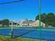 Two tennis courts with green surface and surrounding fence at 4503 Balmoral Nw Rd, Kennesaw, GA 30144