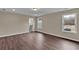 Spacious bedroom with modern vinyl flooring, natural light from two windows, and neutral color scheme at 250 Stonecreek Pkwy, Covington, GA 30016