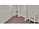 Functional laundry room with vinyl flooring, utility sink, and ample storage space on upper shelving at 250 Stonecreek Pkwy, Covington, GA 30016