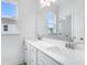 Double vanity bathroom with modern fixtures and bright lighting at 5060 Trescott Path, Cumming, GA 30028