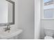 Small bathroom with a sink, toilet and mirror at 5060 Trescott Path, Cumming, GA 30028