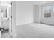 Bright bedroom with grey carpet and en-suite bathroom at 5060 Trescott Path, Cumming, GA 30028