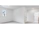 Loft area with grey carpet, white walls, and a door at 5060 Trescott Path, Cumming, GA 30028
