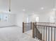 Spacious loft area with grey carpet and a staircase at 5060 Trescott Path, Cumming, GA 30028