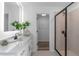 Contemporary bathroom featuring a glass-enclosed shower and a view into a walk-in closet at 3378 Pepperpike Ct, Loganville, GA 30052