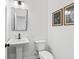 Elegant half bathroom with pedestal sink and neutral-toned walls at 3378 Pepperpike Ct, Loganville, GA 30052