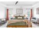 Stylish bedroom featuring a large bed, modern decor, and plenty of natural light from surrounding windows at 3378 Pepperpike Ct, Loganville, GA 30052