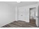 Bedroom with hardwood style floors, closet, and a view to another area of the house at 3378 Pepperpike Ct, Loganville, GA 30052