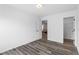 Bright bedroom with gray wood-look flooring and a view into an adjacent living space and closet at 3378 Pepperpike Ct, Loganville, GA 30052