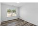Clean and bright bedroom with hardwood style floors and a window overlooking the community at 3378 Pepperpike Ct, Loganville, GA 30052