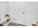 Clean entryway with bench seating, a basket for storage, and a door leading to the interior of the house at 3378 Pepperpike Ct, Loganville, GA 30052