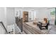 Upstairs living room area with modern furnishings, hardwood style floors, a window and access to the bathroom at 3378 Pepperpike Ct, Loganville, GA 30052