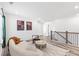 Upstairs living area with modern furnishings, hardwood style floors, a window and access to other areas of the home at 3378 Pepperpike Ct, Loganville, GA 30052