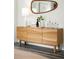 Elegant living room featuring a wood credenza with a lamp, mirror, and candles for a modern aesthetic at 3378 Pepperpike Ct, Loganville, GA 30052