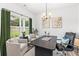 Bright home office with large windows, neutral decor, and modern chandelier at 3378 Pepperpike Ct, Loganville, GA 30052