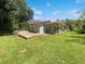 Spacious backyard features a wooden deck and covered parking area at 2492 Brentwood Ct, Decatur, GA 30032