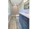 Updated bathroom featuring a walk-in shower and modern vanity with marble style tiling on the floor at 2492 Brentwood Ct, Decatur, GA 30032