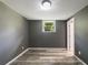 This bedroom has laminate floors, neutral paint, and a window at 2492 Brentwood Ct, Decatur, GA 30032
