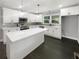 Modern kitchen with white cabinetry, stainless steel appliances, a large island, and stylish pendant lighting at 2492 Brentwood Ct, Decatur, GA 30032