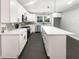 Newly renovated kitchen with white cabinets, stainless steel appliances, quartz countertops and large island at 2492 Brentwood Ct, Decatur, GA 30032