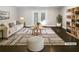 Bright living room featuring a modern rug, comfortable seating, built-in shelving, and access to the backyard at 2492 Brentwood Ct, Decatur, GA 30032