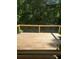 Large wooden back deck with cable railing overlooking a lush green wooded area at 1041 Kennesborough Nw Rd, Kennesaw, GA 30144