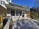 View of a wooden back deck and the back of the house, including an air conditioning unit at 1041 Kennesborough Nw Rd, Kennesaw, GA 30144