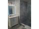 Bathroom with a vanity with marble countertop, a walk-in shower, and unique lighting at 1041 Kennesborough Nw Rd, Kennesaw, GA 30144