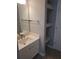 Bathroom sink with large mirror and open shelved storage area at 1041 Kennesborough Nw Rd, Kennesaw, GA 30144