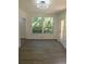Bright dining area featuring wood-look flooring and large windows with a view of the surrounding greenery at 1041 Kennesborough Nw Rd, Kennesaw, GA 30144