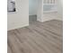 Open dining space with wood-look flooring, white walls, and white cabinets at 1041 Kennesborough Nw Rd, Kennesaw, GA 30144