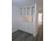 Dining area features gray wood-look floors, white walls, and white cabinets with glass doors at 1041 Kennesborough Nw Rd, Kennesaw, GA 30144