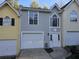 This home has a bright garage door and a stucco façade with a large front door at 1041 Kennesborough Nw Rd, Kennesaw, GA 30144