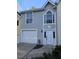 This home has a bright garage door and a stucco façade with a large front door at 1041 Kennesborough Nw Rd, Kennesaw, GA 30144