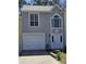 Charming home featuring a clean white garage door, elegant white trim, and stucco facade at 1041 Kennesborough Nw Rd, Kennesaw, GA 30144
