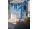 Charming home featuring a clean white garage door, elegant white trim, and vibrant blue stucco facade at 1041 Kennesborough Nw Rd, Kennesaw, GA 30144