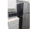 Close-up of the kitchen featuring stainless steel refrigerator and modern microwave appliance at 1041 Kennesborough Nw Rd, Kennesaw, GA 30144