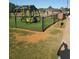 A community playground for families features modern, colorful equipment and safety fencing at 1041 Kennesborough Nw Rd, Kennesaw, GA 30144