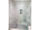 Modern bathroom shower with glass door and sleek, attractive gray and white marble-look tile at 1041 Kennesborough Nw Rd, Kennesaw, GA 30144