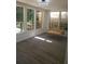 Cozy sunroom with natural light, hanging swing, and wood-look floors at 1041 Kennesborough Nw Rd, Kennesaw, GA 30144